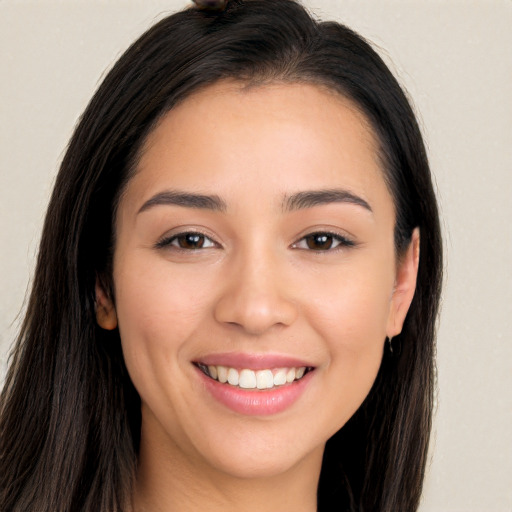 Joyful white young-adult female with long  brown hair and brown eyes