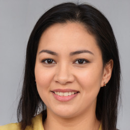 Joyful asian young-adult female with long  brown hair and brown eyes