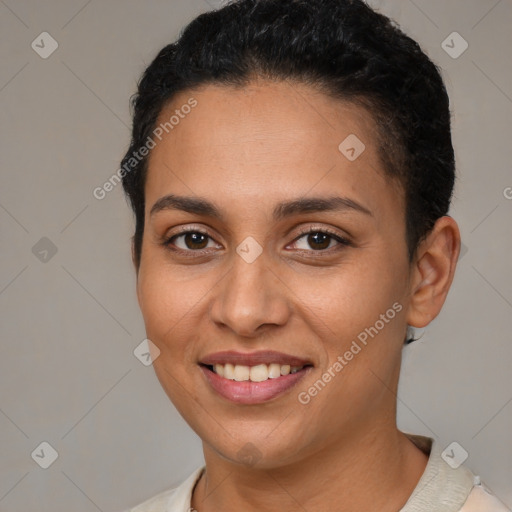 Joyful latino young-adult female with short  brown hair and brown eyes