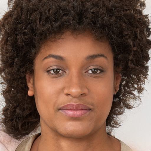 Joyful black young-adult female with medium  brown hair and brown eyes