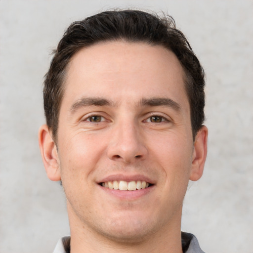 Joyful white young-adult male with short  brown hair and brown eyes