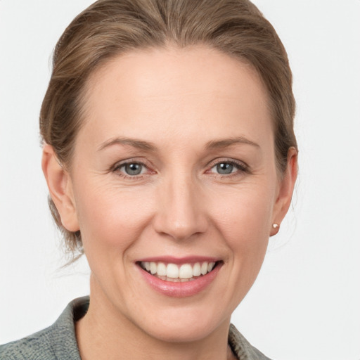 Joyful white adult female with medium  brown hair and grey eyes