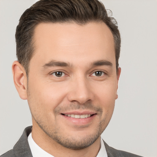 Joyful white young-adult male with short  brown hair and brown eyes