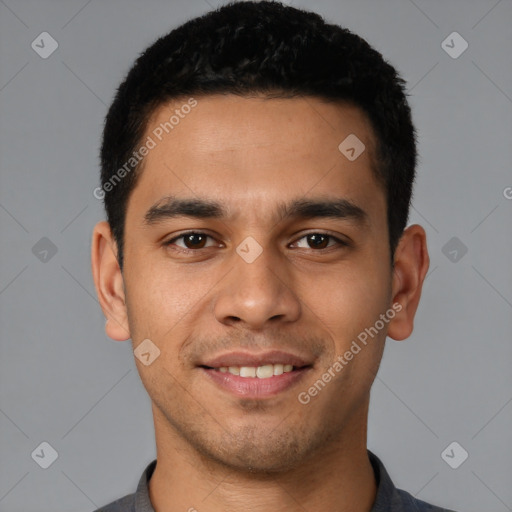 Joyful latino young-adult male with short  black hair and brown eyes