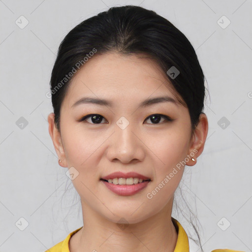 Joyful asian young-adult female with short  black hair and brown eyes