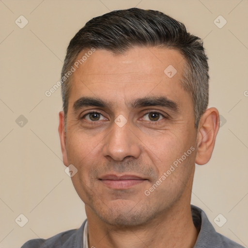 Joyful white adult male with short  black hair and brown eyes