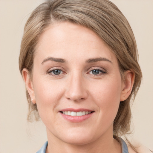 Joyful white young-adult female with medium  brown hair and blue eyes