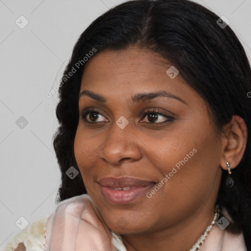 Joyful black young-adult female with long  brown hair and brown eyes