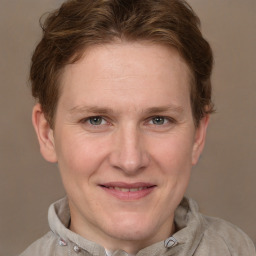 Joyful white adult male with short  brown hair and grey eyes