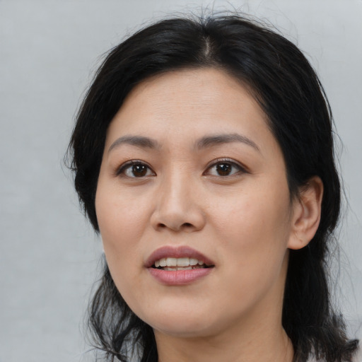 Joyful asian young-adult female with medium  black hair and brown eyes