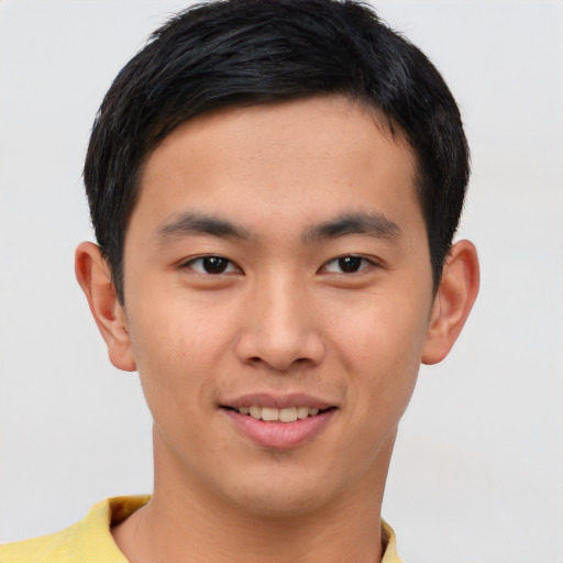 Joyful asian young-adult male with short  brown hair and brown eyes