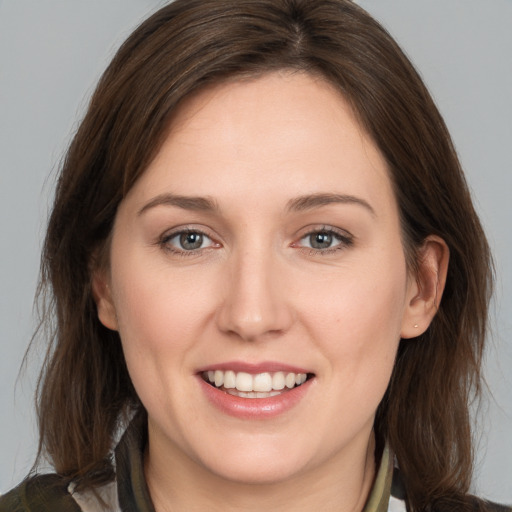 Joyful white young-adult female with medium  brown hair and brown eyes