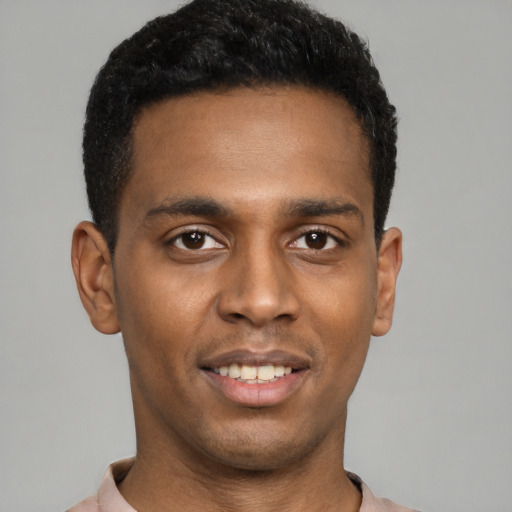 Joyful latino young-adult male with short  black hair and brown eyes