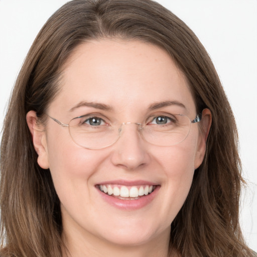 Joyful white adult female with long  brown hair and grey eyes