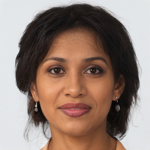 Joyful black adult female with medium  brown hair and brown eyes