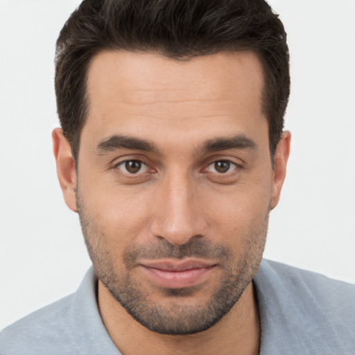 Joyful white young-adult male with short  brown hair and brown eyes