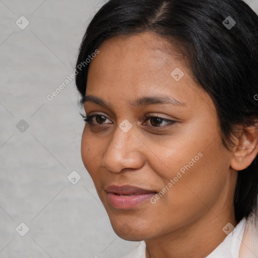 Joyful latino young-adult female with medium  brown hair and brown eyes