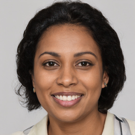 Joyful black young-adult female with medium  brown hair and brown eyes