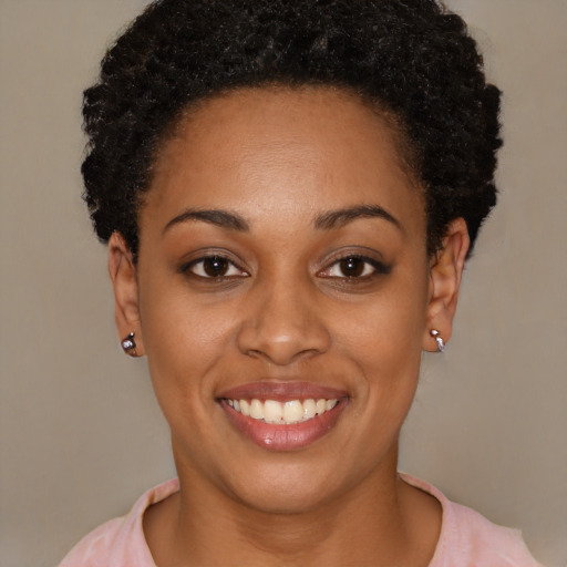 Joyful black young-adult female with short  black hair and brown eyes