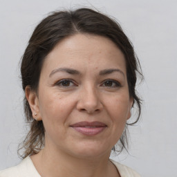 Joyful white adult female with medium  brown hair and brown eyes