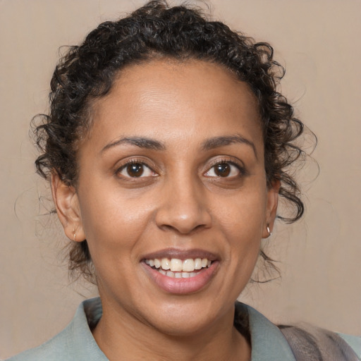 Joyful black young-adult female with medium  brown hair and brown eyes