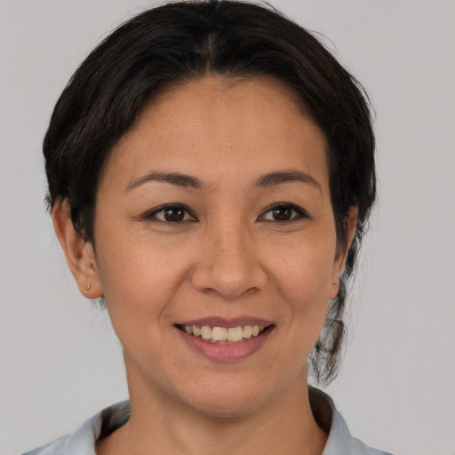 Joyful asian adult female with short  brown hair and brown eyes