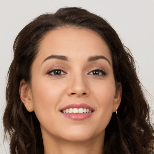 Joyful white young-adult female with long  brown hair and brown eyes