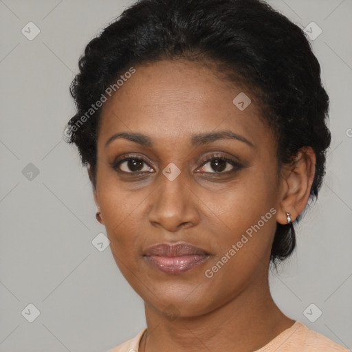 Joyful black adult female with short  black hair and brown eyes