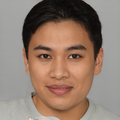 Joyful asian young-adult male with short  brown hair and brown eyes