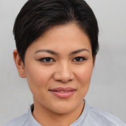 Joyful asian young-adult female with short  brown hair and brown eyes