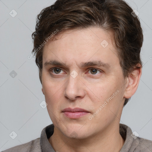 Joyful white adult male with short  brown hair and grey eyes