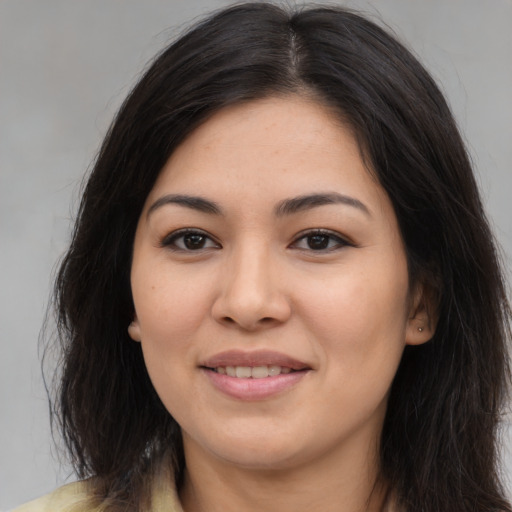 Joyful asian young-adult female with long  brown hair and brown eyes