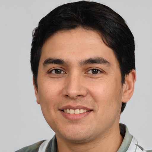 Joyful white young-adult male with short  black hair and brown eyes