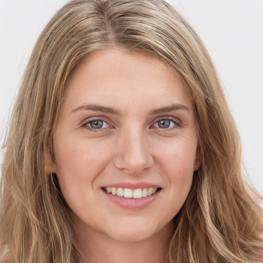 Joyful white young-adult female with long  brown hair and green eyes