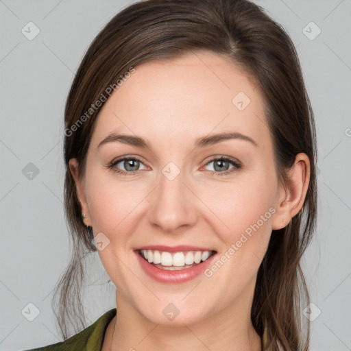 Joyful white young-adult female with medium  brown hair and grey eyes