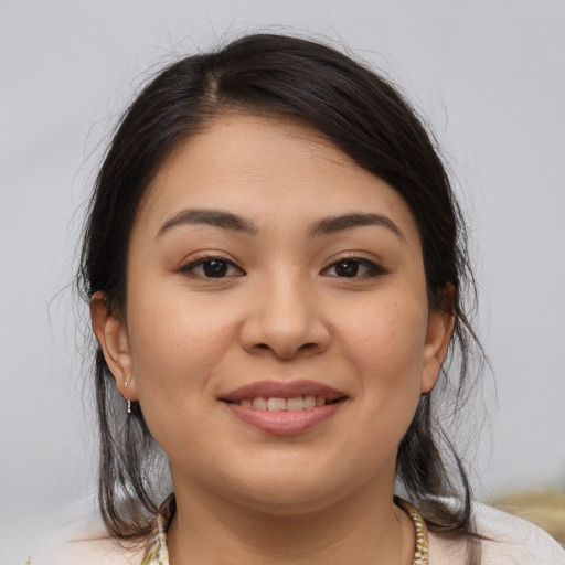 Joyful latino young-adult female with medium  brown hair and brown eyes