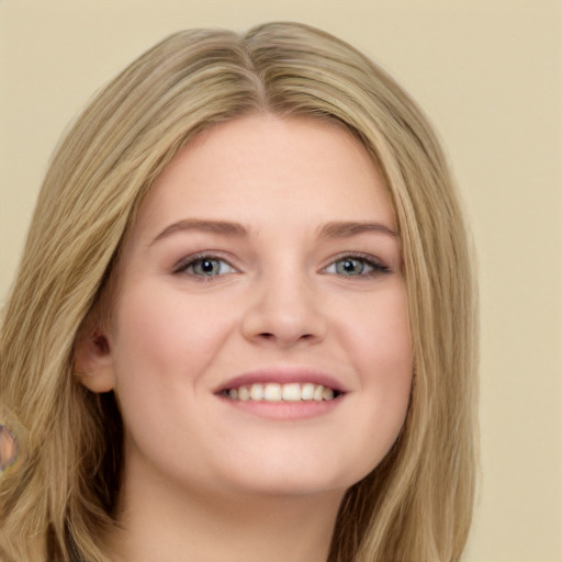 Joyful white young-adult female with long  brown hair and green eyes