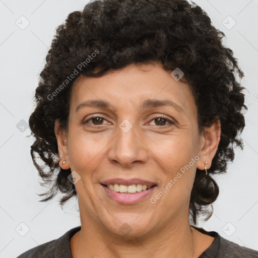 Joyful latino adult female with medium  brown hair and brown eyes