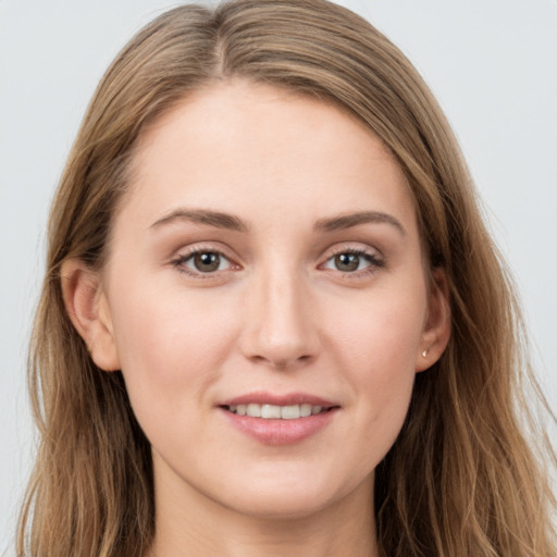 Joyful white young-adult female with long  brown hair and grey eyes