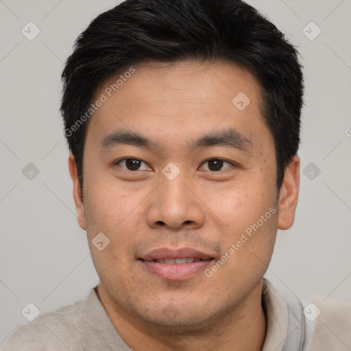 Joyful asian young-adult male with short  black hair and brown eyes