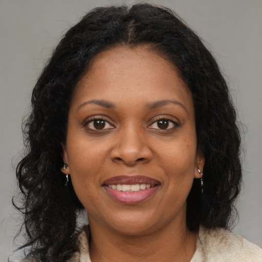 Joyful black young-adult female with medium  brown hair and brown eyes