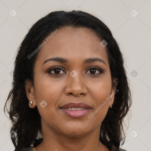 Joyful black young-adult female with long  brown hair and brown eyes