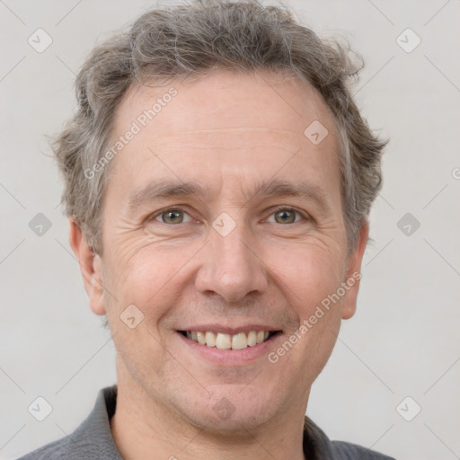 Joyful white adult male with short  brown hair and grey eyes