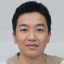 Joyful asian young-adult male with short  black hair and brown eyes