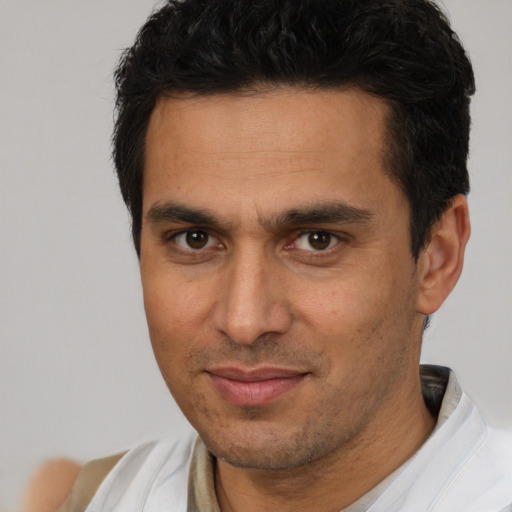 Joyful white adult male with short  brown hair and brown eyes