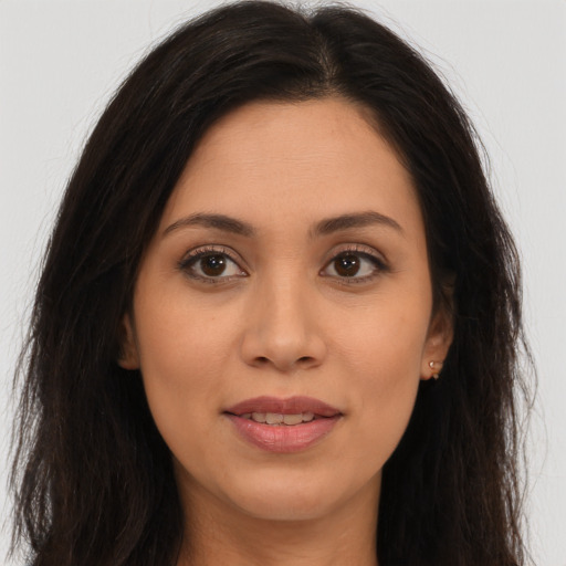 Joyful latino young-adult female with long  brown hair and brown eyes