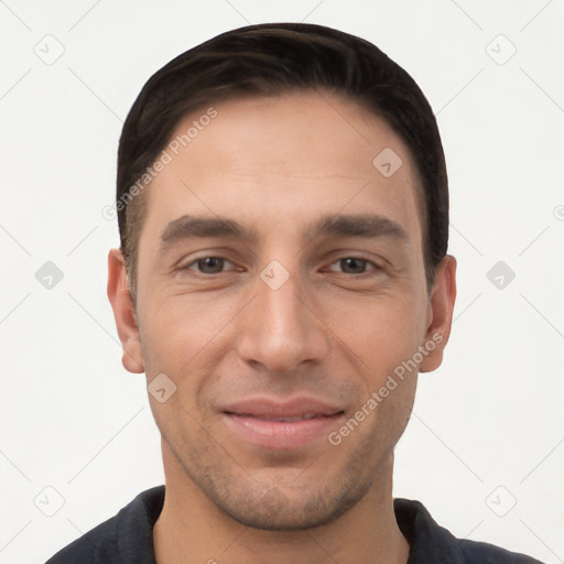 Joyful white young-adult male with short  black hair and brown eyes