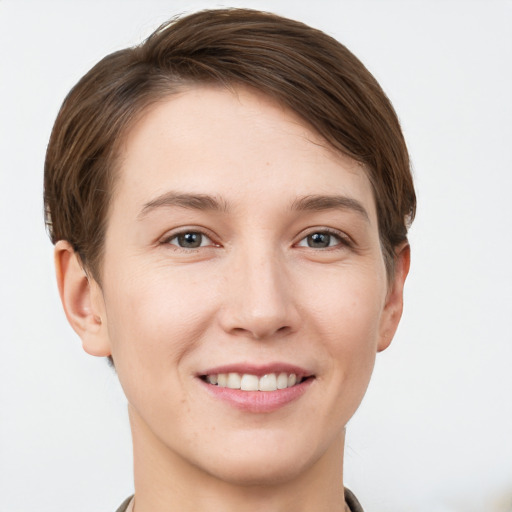 Joyful white young-adult female with short  brown hair and grey eyes