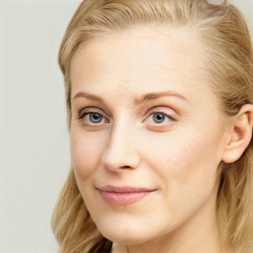 Joyful white young-adult female with long  brown hair and blue eyes