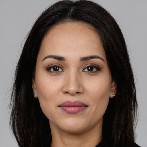 Joyful white young-adult female with long  brown hair and brown eyes